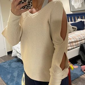 Light pink/tan sweater with cuts in the sleeves. Never worn size medium
